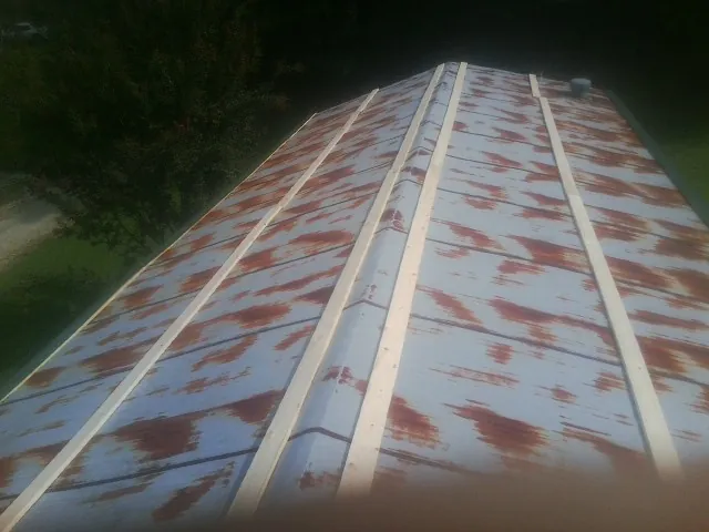 Rusted metal roof panels with new wood purlins before replacement — Storm Damage Roof Repair in Rocky Point by Roofing Brothers